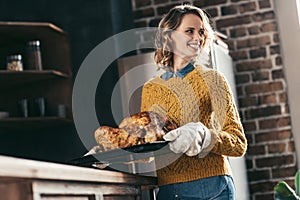 young beautiful woman carrying tray with delicious turkey