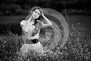 Young beautiful woman on cereal field with poppies in summer - b