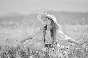 Young beautiful woman on cereal field with poppies in summer