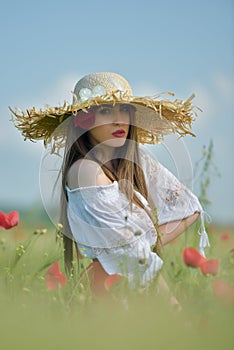 Young beautiful woman on cereal field in summer