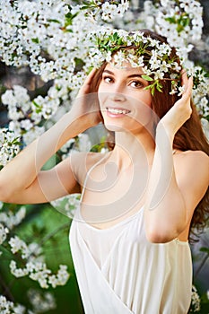 Young beautiful woman in circlet of flowers