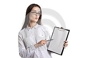 Young beautiful woman with a clipboard in his hands. Long-haired brunette in glasses and a white shirt. The woman points to the cl