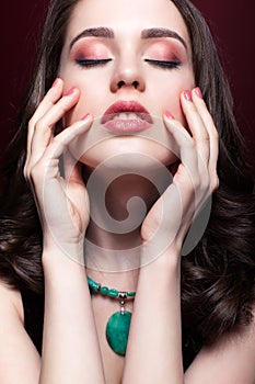 Young beautiful woman with closed eyes on red marsala background