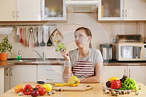 Young beautiful woman is cooking in the kitchen.