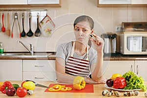 Young beautiful woman is cooking in the kitchen.