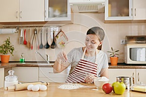 Young beautiful woman is cooking in the kitchen.