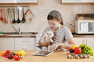 Young beautiful woman is cooking in the kitchen.