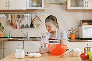 Young beautiful woman is cooking in the kitchen.