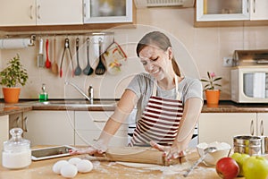 Young beautiful woman is cooking in the kitchen.