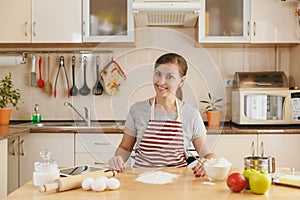 Young beautiful woman is cooking in the kitchen.