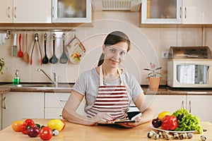 Young beautiful woman is cooking in the kitchen.