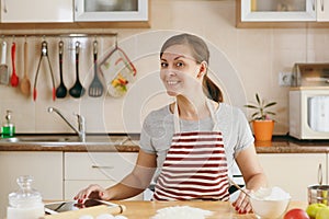 Young beautiful woman is cooking in the kitchen.