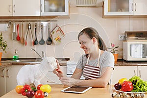 Young beautiful woman is cooking in the kitchen.