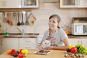 Young beautiful woman is cooking in the kitchen.