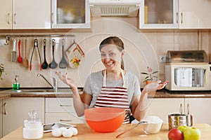 Young beautiful woman is cooking in the kitchen.