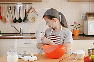 Young beautiful woman is cooking in the kitchen.