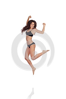 Young beautiful woman in cotton underwear jumping