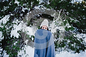 Young beautiful woman covered in blanket at the mountain. Relax and nature