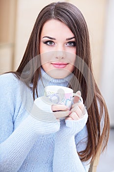 Young beautiful woman with cup at home