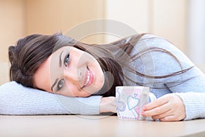 Young beautiful woman with cup at home