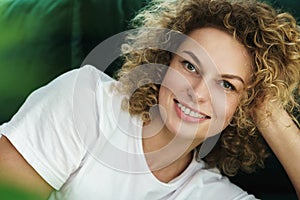 Young beautiful woman with a curly hair and smooth skin