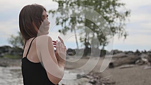 Young beautiful woman dancing on the seashore