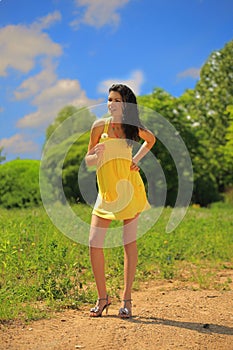 Young beautiful woman with dandelion flower outdo