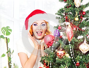 Young and beautiful woman decorating Christmas tree