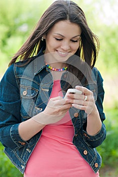 Young Beautiful woman & digital device outdoors photo