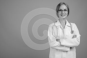 Young beautiful woman doctor with blond hair in black and white