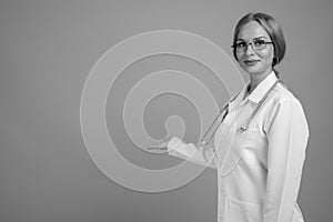 Young beautiful woman doctor with blond hair in black and white
