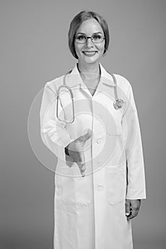 Young beautiful woman doctor with blond hair in black and white