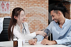 Young beautiful woman doctor is health examining a male patient