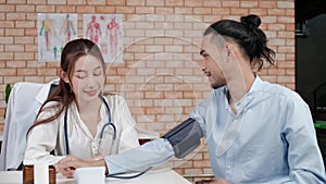 Young beautiful woman doctor is health examining a male patient.