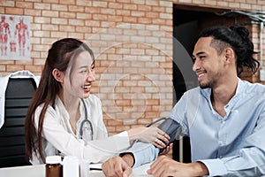 Young beautiful woman doctor is health examining a male patient