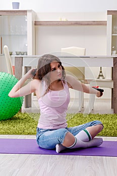 Young beautiful woman doing exercises at home