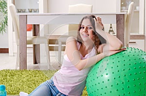 The young beautiful woman doing exercises at home