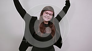 Young beautiful woman doing winner gesture with arms raised, laughing