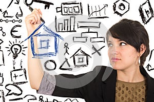 Young beautiful woman drawing a house with marker