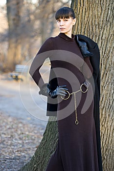 Young beautiful woman in dress standing outside