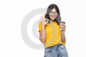 Young beautiful woman drinking cup of takeaway coffee over white background doing ok sign with fingers, excellent symbol