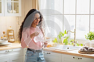 Young Beautiful Woman Drinking Water In Kitchen At Home