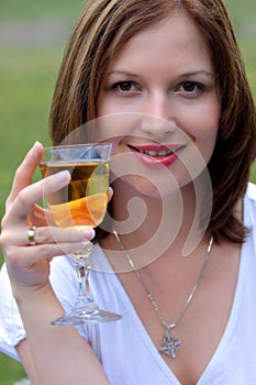 Young beautiful woman drinking wine outdoor