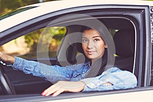 Young beautiful woman driving her car