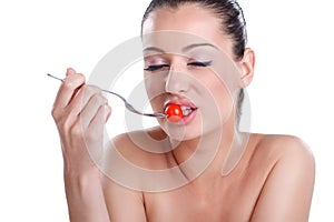 Young beautiful woman eating fresh Cherry tomatoes