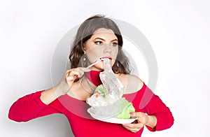 Young beautiful woman eating a plastic bag as a concept of plastic contaminated food. Ecology concept