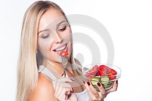 Young beautiful woman eats vegetable salad. Healthy eating. To be in shape.