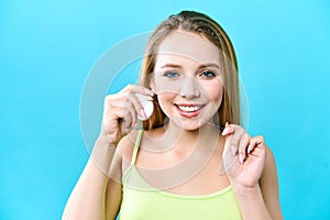 Young beautiful woman is engaged in cleaning teeth. Beautiful smile healthy white teeth. A girl holds a dental floss