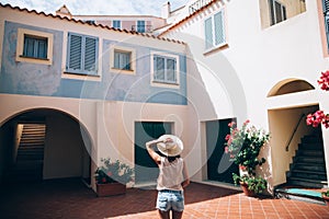 Young beautiful woman enjoy cozy Italy courtyard in Sardinia isl