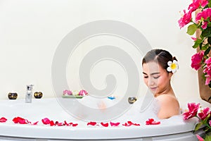 Young beautiful woman enjoying in bathtub at spa salon